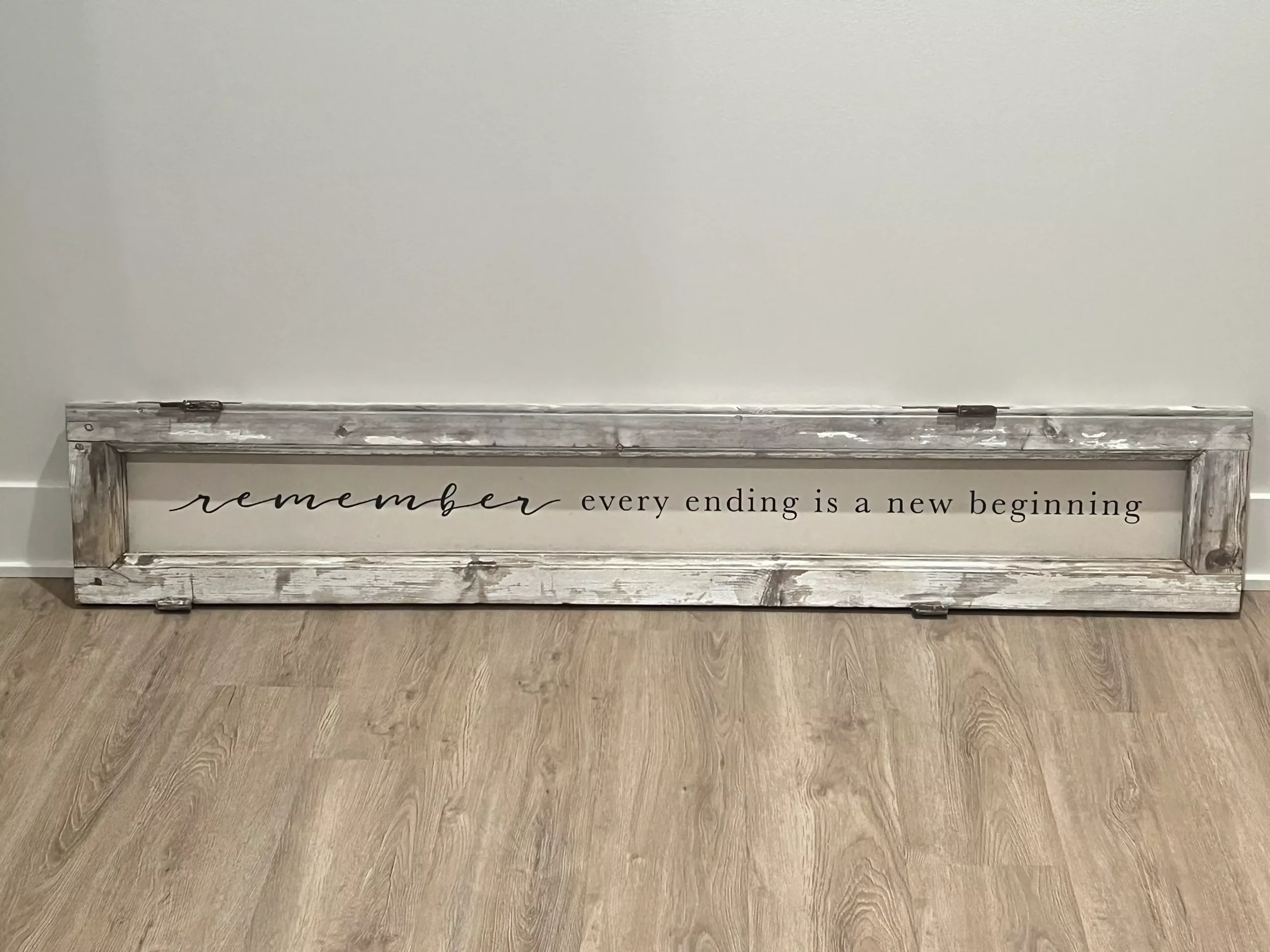 handcrafted "remember every ending is a new beginning" sign